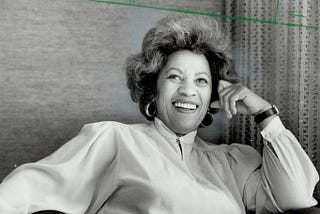 Black and white photo of Toni Morrison smiling.