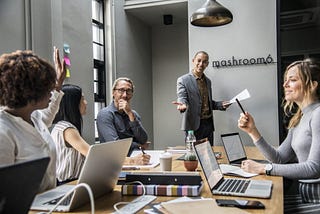 Team leader in a meeting with his team