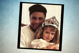 A Polaroid-looking portrait of a Black man with short hair hugging a child with shoulder-length hair and wearing a tiara.