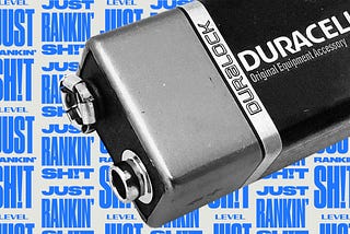 A partial view of a Duracell D battery in black & white against a background with the repeating text “Just Rankin’ Shit.”