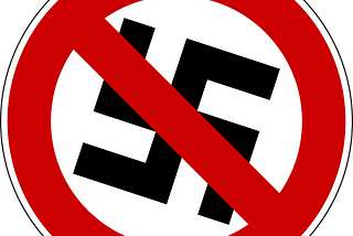 A picture of a swastika enclosed inside a red circle with a broad red line through the center of the swastika as if to say “no Swastikas allowed”