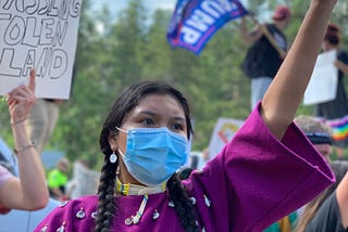Indigenous woman wearing face mask at a protest in July.