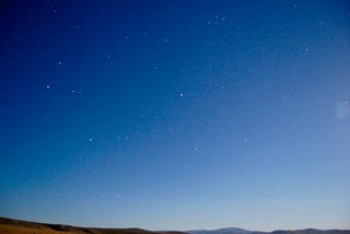 A photo of the blue Oregon summer sky with some stars.