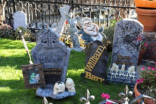 3 lawn decoration headstones: Kellyanne Conwoman, William Barr, Rudi Guiliani.