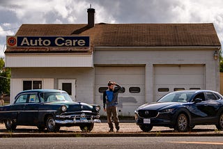 I look questioningly at my car parked next to an old beater, wondering why I chose the vehicle I did.