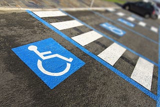 Close up of handlcapped symbol in a parking place.