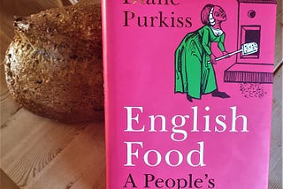 Book of “English Food” with a loaf of bread on simple wooden table. Picture by Edward Breen, 2023.