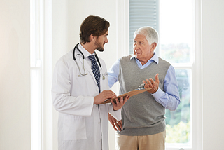 Picture of a man talking to a doctor.