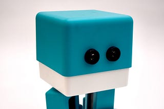 A cute little robot figurine.