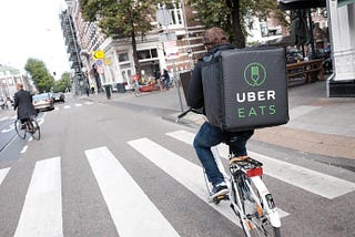 UberEats Rider cycling on the road.