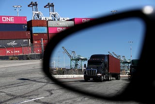 A truck loaded with a shipping container drives through the Port of Oakland on September 03, 2019 in Oakland, California.