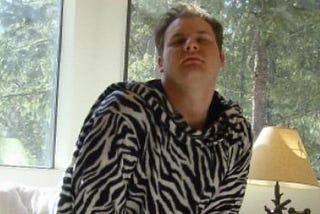 A young me adorned in a zebra-print snuggie luxuriates atop a pile of very real crypto coins