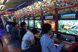 People playing Street Fighter 4 in an Arcade