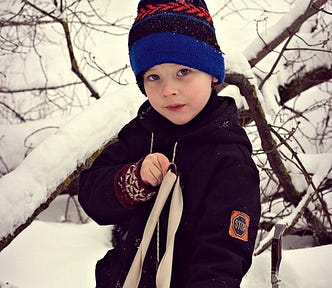 A boy with a slingshot in his hands