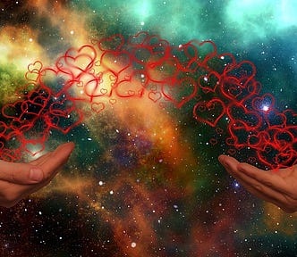 A photograph of two hands with background graphics of colorful univers with stars and both hands are connected by outlines of several hearts