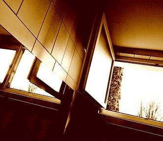 Photography of an open window and its reflection in a mirror.