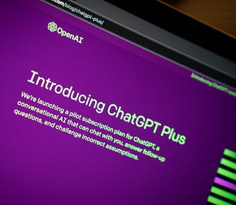 A computer monitor on an angle on the purple ChatGPT home page, advertising “ChatGPT Plus.”