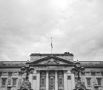 A black and white close-up picture of the front of Buckingham Palace.