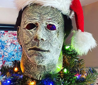 Michael Myers mask wearing a Santa hat as a tree topper.