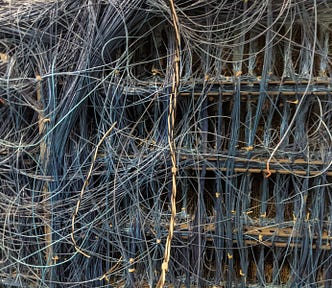 The complex, hand-wired backplane of an electromechanical supercomputer at the Computer History Museum boneyard; it is an impossible tangle of wires joining various subassemblies.