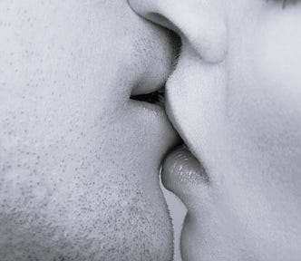 young Caucasian couple kissing in close-up