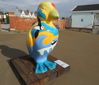 A very large colourful plastic puffin sculpture situated on the Promenade of an English coastal town to raise awareness of endangered wildlife on our seas and coast.