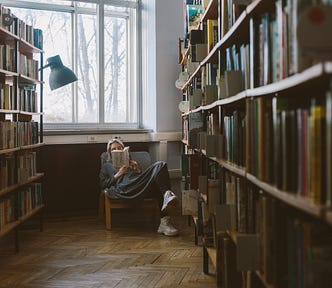 woman reading a book in a library
