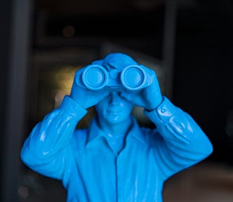 Tight closeup of a bright blue plastic soldier looking at you through binoculars — alt text to boost Medium stories in SEO