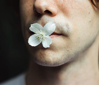Man with a flower in his mouth
