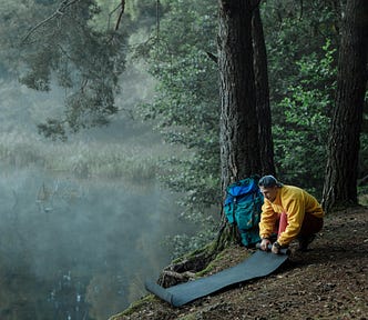 a hiker sitting on a mountain