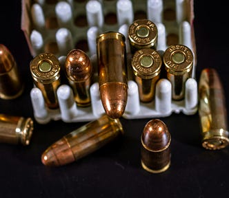 a package of brass bullets — guns and ammo