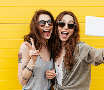 women taking selfies or videos