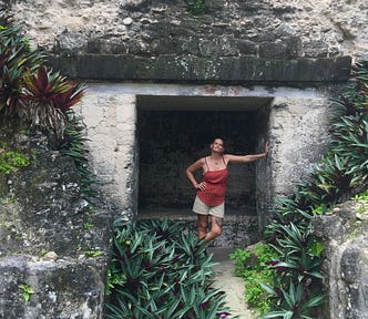Author stands inside a stone doorway of a Mayan temple in Guatemala