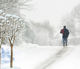 Man on a meditative walk in gentle winter snow contemplating the meainngs of winter and life