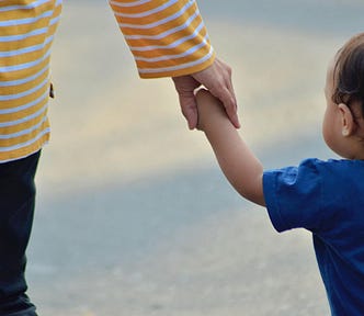 Mother leading a toddler by the hand