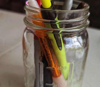 A jar of pens for writing.