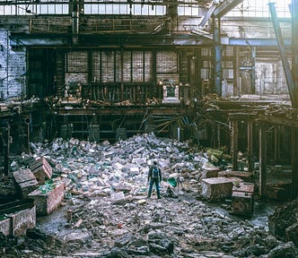 semi-destroyed building full of debris from collapsed roof and walls