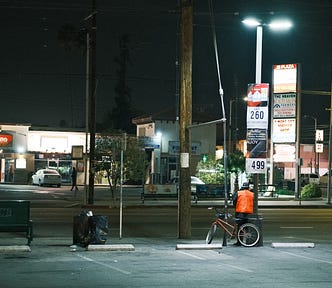 Saw this guy waiting under the lights for a good while around 11 PM — even after a bus had come through. || Photo by author