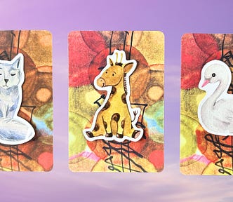 Three oracle card piles with animal stickers on them