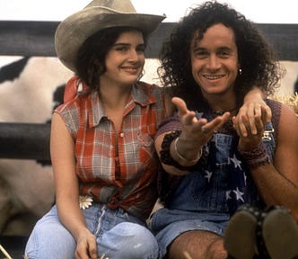 Still of Carla Gugino and Pauly Shore sitting near haystack in proof photo for 1993’s “Son in Law”