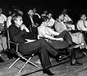 Photograph of the 1946 colloquium on the Super at Los Alamos. Front row left to right: Norris Bradbury, John Manley, Enrico Fermi and J.M.B. Kellogg. Second row left to right: Colonel Oliver G. Haywood, unknown, Robert Oppenheimer, Richard Feynman, Phil B. Porter. Third row left to right: : Edward Teller, Gregory Breit, Arthur Hemmendinger, Arthur Schelberg.