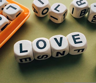 A Boggle game with the letter blocks spelling out “LOVE.”