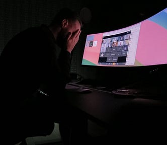 Matej Latin sitting behind his desk despairing with his head in his hands.