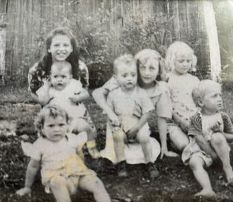 Old black and white photo from the 1940s showing Appalachian children posing together.