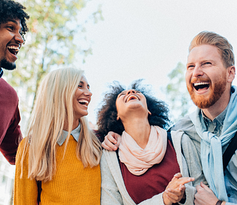 5 multicultural people laughing together