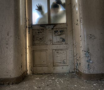Beat up door with person visible on the other side of a frosted panel (kinda scary)