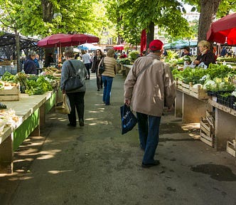 Farmer’s market with produce and people shopping