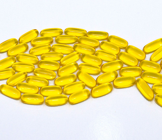 fish oil capsules arranged to look like a fish