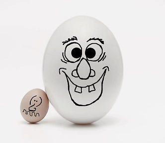 Big egg with happy face, little egg with miserable face against white background. Courtesy  daniele-levis-pelusi-unsplash modified by Witz Fine Arts.