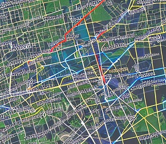 An illustrative city map of an unidentified city showing highlighted streets and some topography, but with no labels.